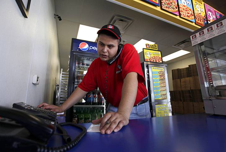 24 2012 Pizza Patron store manager Jose Gomez takes a phone order in Dallas Texas