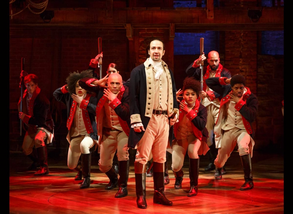 This image released by The Public Theater shows Lin Manuel Miranda foreground with the cast during a performance of'Hamilton' in New York