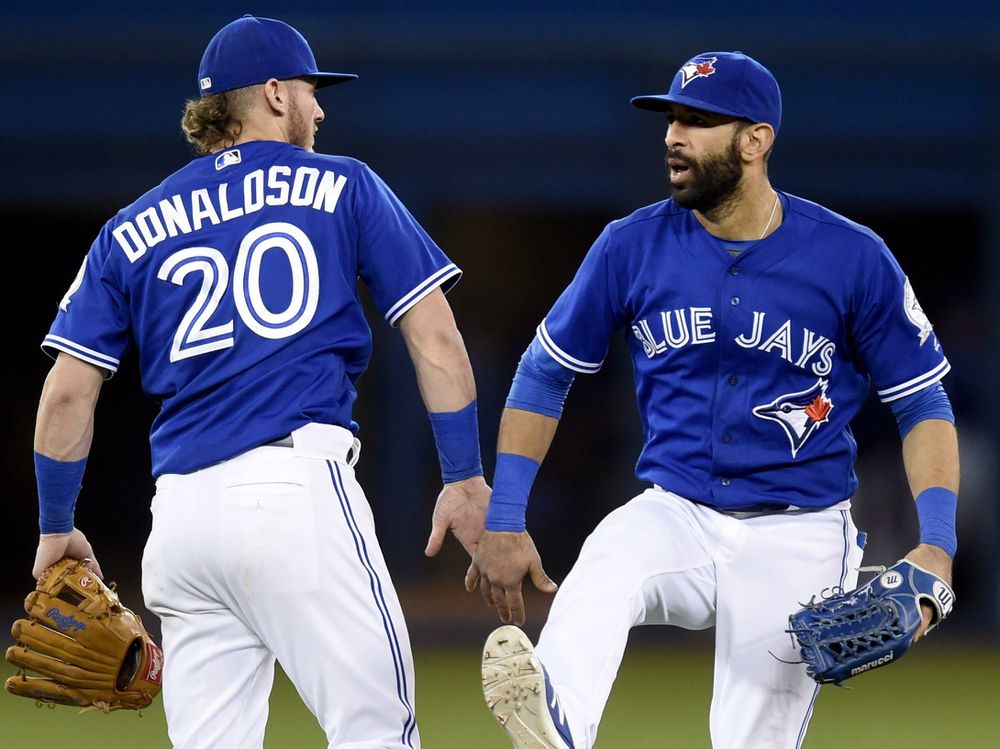 Toronto Blue Jays&#039 Josh Donaldson and Jose Bautista celebrates the team's 6-3 win against the Oakland Athletics on Sunday