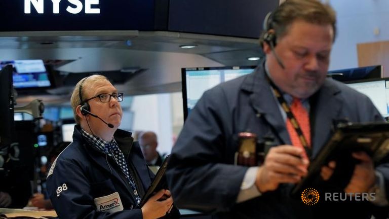 Traders work on the floor of the New York Stock Exchange in New York City U.S