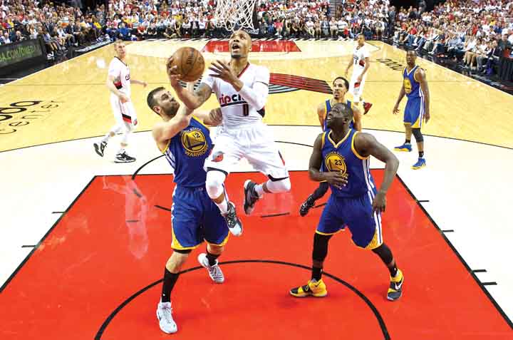 Damian Lillard of the Portland Trail Blazers goes for a layup against Andrew Bogut of the Golden State Warriors during Game 3 of their NBA Western Conference semifinal series. Portland won 120-108