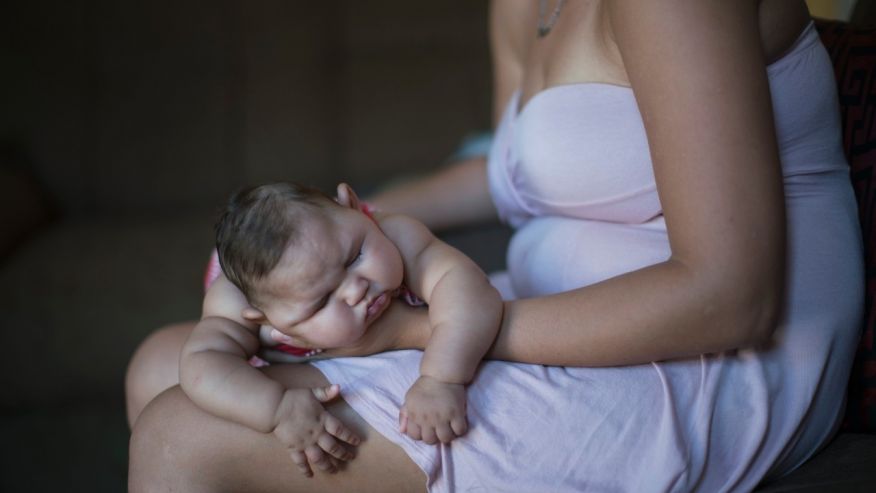 Gleyse Kelly da Silva holds her daughter Maria Giovanna as she sleeps in their house in Recife Pernambuco state Brazil Wednesday Jan. 27 2016. Brazilian officials still say they believe there's a sharp increase in cases of microcephaly and stron