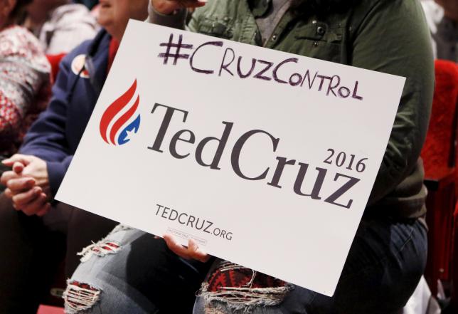 A supporter holds a campaign sign as she listens Republican Presidential candidate U.S. Senator Ted Cruz speak during a campaign rally in Orono Maine