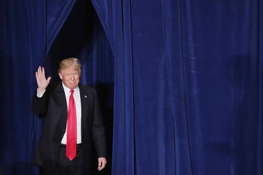 Republican presidential candidate Donald Trump walks out from backstage before delivering a speech about his vision for foreign policy at the Mayflower Hotel