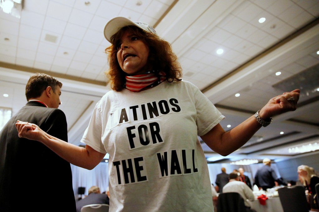 Luisa Aranda of Brentwood wears a shirt in support of the border wall while waiting for Republican U.S. presidential candidate Donald Trump during the California GOP convention in Burlingame California U.S