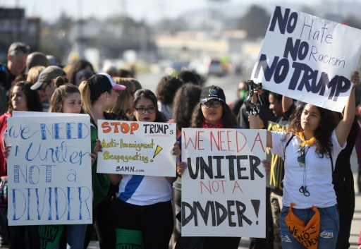 AFP  Josh Edelson. Protesters hold up signs during a rally against US Republican presidential candidate Donald Trump in Burlingame California