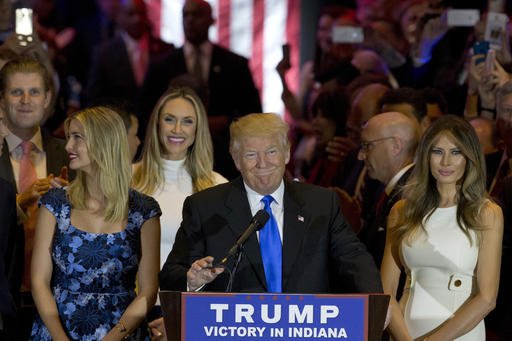 Republican presidential candidate Donald Trump is joined by his wife Melania right and daughter Ivanka left as he arrives for a primary night news conference Tuesday