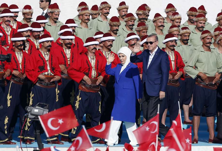 Turkey's President Recep Tayyip Erdogan and his wife Emine Erdogan wave as they arrive to attend ceremonies marking the 563rd anniversary of the conquest of the city by Ottoman Turks in Istanbul Turkey Sunday