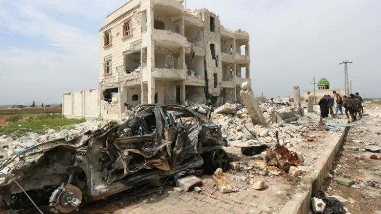 Syrians walk through the rubble following an alleged bombing by Islamic State group in Marea northern Aleppo