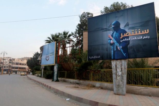 ISIS billboards are seen along a street in Raqqa