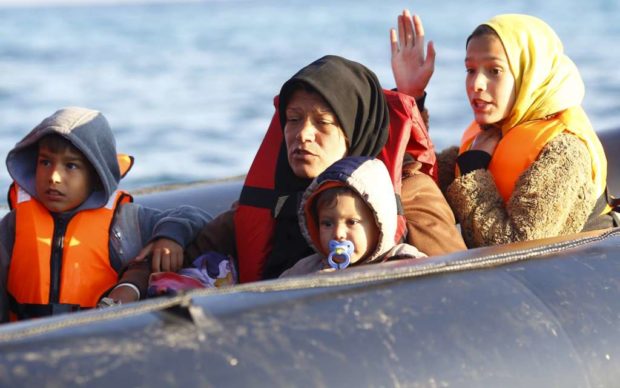 Refugees aboard a dinghy sail off for the Greek island of Chios as they try to travel from the western Turkish coastal town of Cesme in Izmir province Turkey. Reuters