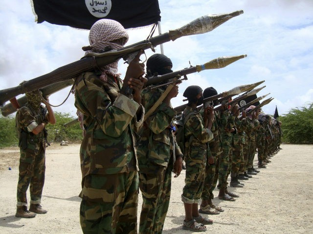 Al Shabaab militants parade new recruits after arriving in Mogadishufrom their training camp south of the capital in this