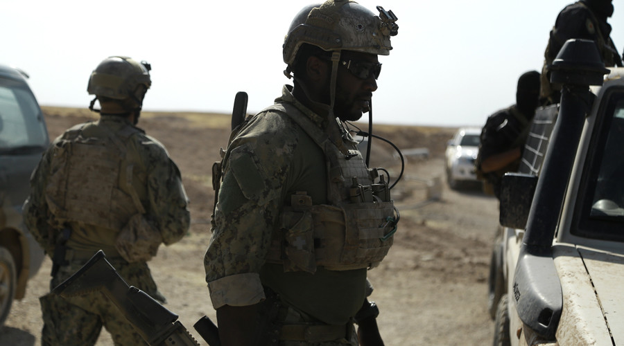 Armed men in uniform identified by Syrian Democratic forces as US special operations forces are seen in the village of Fatisah in the northern Syrian province of Raqa