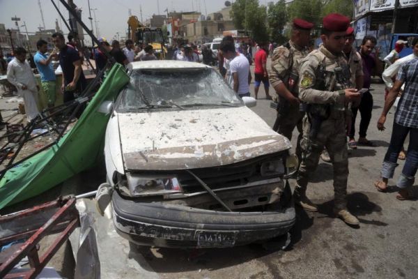 Security forces and citizens inspect the scene after