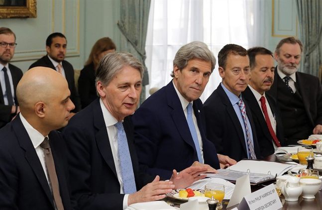 U.S. Secretary of State John Kerry center and Britain's Foreign Secretary Phillip Hammond second left attend a meeting in central London Thursday