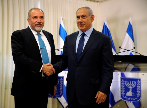 Avigdor Lieberman head of far-right Yisrael Beitenu party  and Israeli Prime Minister Benjamin Netanyahu shake hands after signing a coalition deal to broaden the government's parliamentary majority at the Knesset the Israeli parliament in Jer