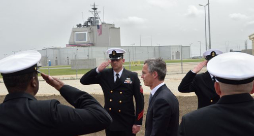 NATO Secretary General Jens Stoltenberg reviews an honor guard during an inauguration ceremony of the U.S. anti-missile station Aegis Ashore Romania at the military base in Deveselu Romania