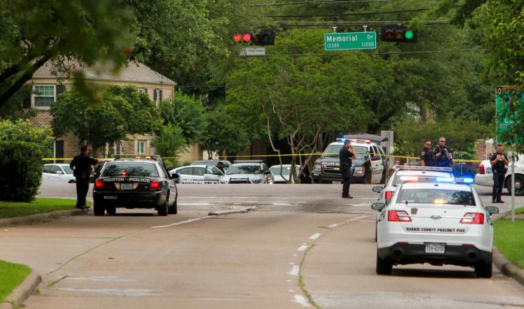 Police block the intersection at Memorial and Wilcrest as they respond to a shooting where authorities say a gunman and at least one other person are dead Sunday