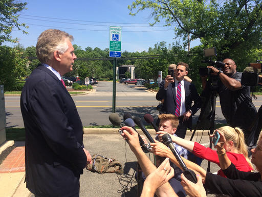 Virginia Gov. Terry Mc Auliffe speaks to reporters following a scheduled event at a parole and probation office in Alexandria Va. Tuesday