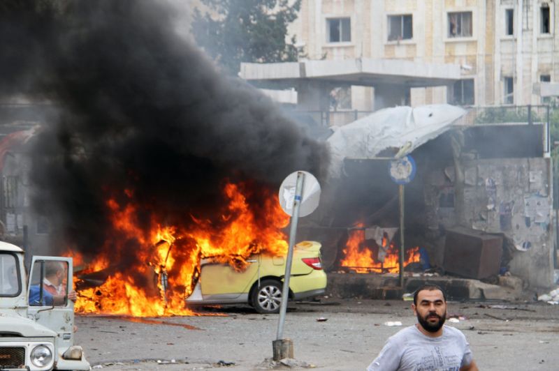 A car in flames at the scene of bombings in the Syrian city of Tartus northwest of Damascus