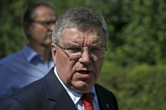 International Olympic Committee President Thomas Bach talks to journalists following a wreath-laying ceremony at the monument of Pierre de Coubertin at the site of ancient Olympia in Greece