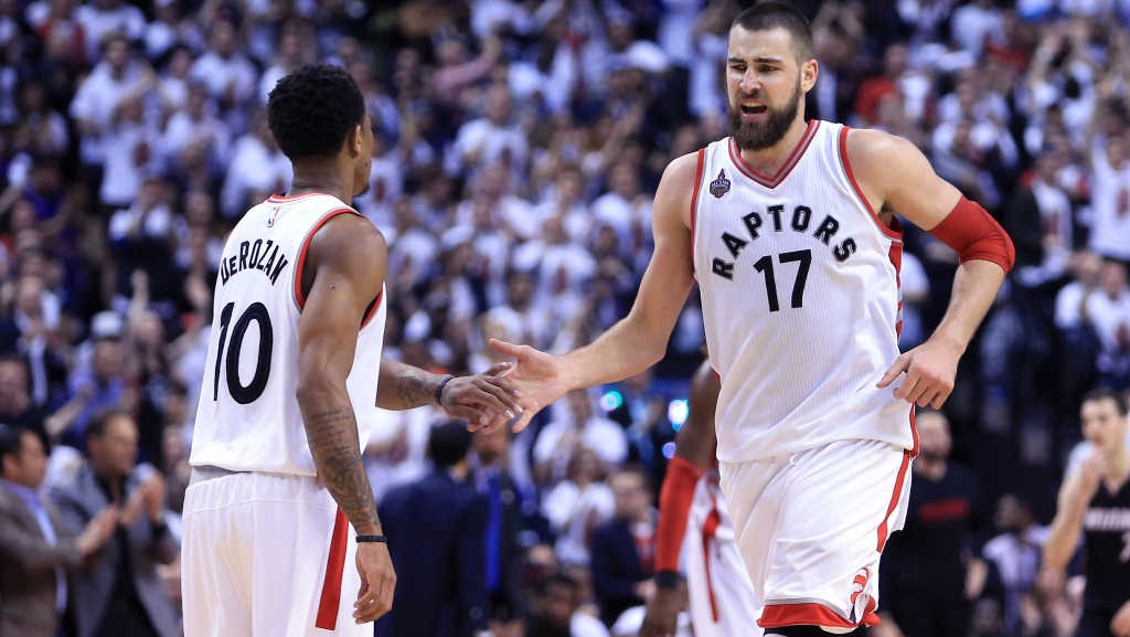 TORONTO ON- MAY 05 De Mar DeRozan #10 of the Toronto Raptors high-fives Jonas Valanciunas #17 in the second half of Game Two of the Eastern Conference Semifinals against the Miami Heat during the 2016 NBA Playoffs at the Air Canada Centre