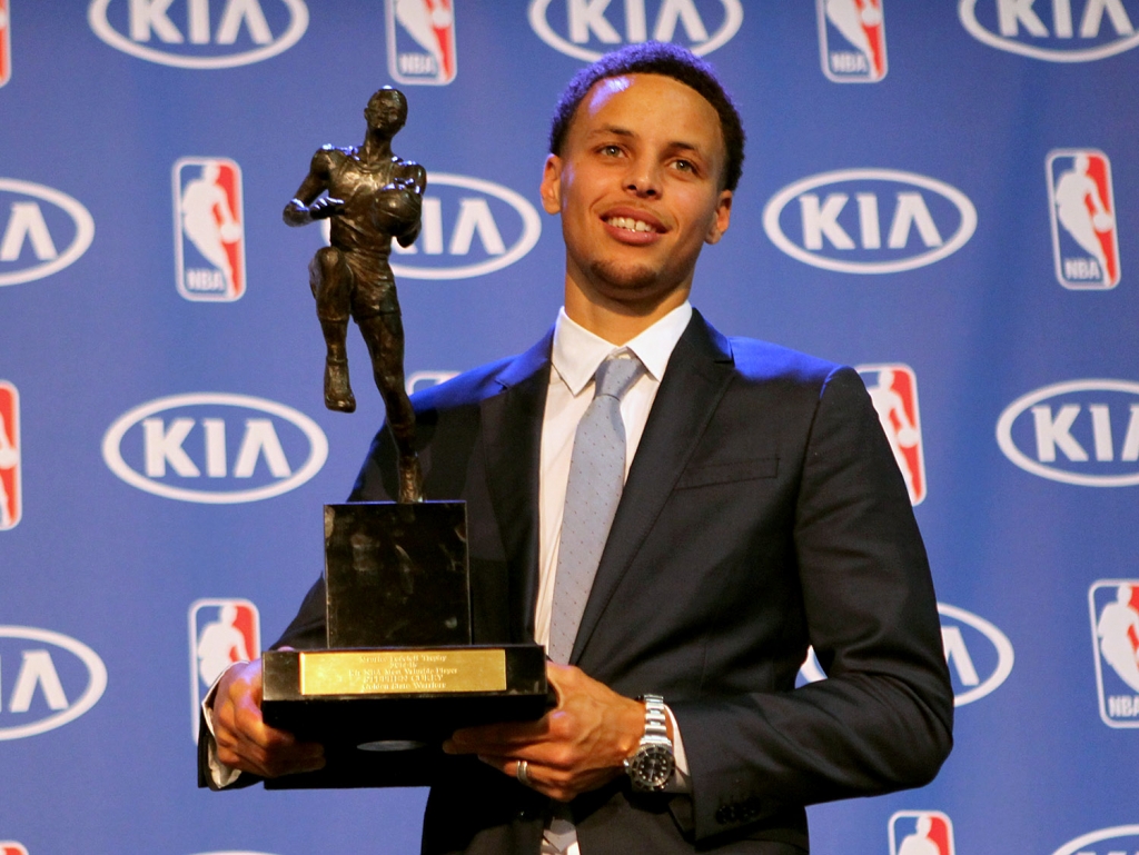 Golden State Warriors guard Stephen Curry accepts the NBA KIA Most Valuable Player for the 2014-2015 Season at the Warriors Training Facility in Oakland Calif. on Monday