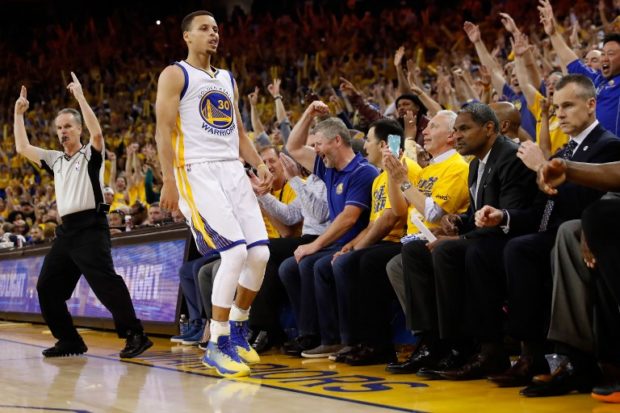 OAKLAND CA- MAY 18 Stephen Curry #30 of the Golden State Warriors reacts to his three-point shot against the Oklahoma City Thunder during game two of the Western Conference Finals during the 2016 NBA Playoffs at ORACLE Arena