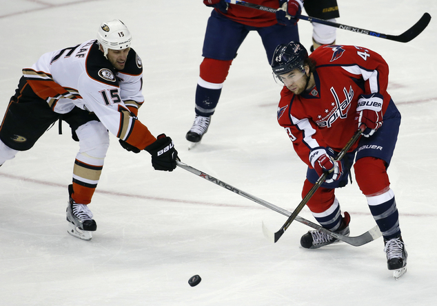 Washington Capitals right wing Tom Wilson passes the puck as Anaheim Ducks center Ryan Getzlaf defends