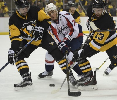 Washington’s T.J. Oshie middle can’t find a way around Pittsburgh’s Justin Schult left and Nick Bonino