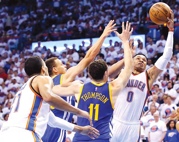 Russell Westbrook of the Oklahoma City Thunder goes for a layup against Stephen Curry and Klay Thompson of the Golden State Warriors during Game 4 of their NBA Western Conference Finals series. The Thunder won 118-94 to gain a commanding 3-1 lead