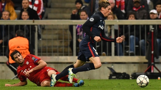 Atletico Madrid's forward Fernando Torres is fouled by Bayern Munich's Spanish midfielder Javier Martinez for a penalty during the UEFA Champions League semifinal Bayern Munich and Atletico Madrid in Munich Tuesday