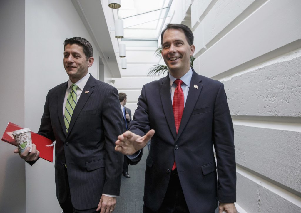 U.S. House Speaker Paul Ryan R-Wis. left arrives with former GOP presidential candidate Wisconsin Gov. Scott Walker for a meeting of House Republicans on Capitol Hill in Washington. Wisconsin Republicans stru