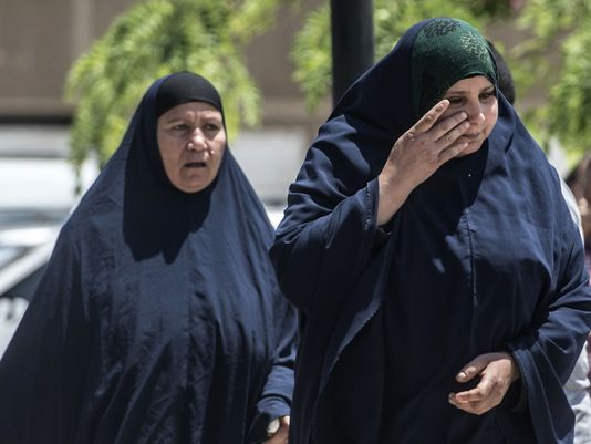 A relative of a passenger who was flying aboard an Egypt Air plane that vanished from radar en route from Paris to Cairo overnight cries as family members are transported by bus to a gathering point at Cairo airport