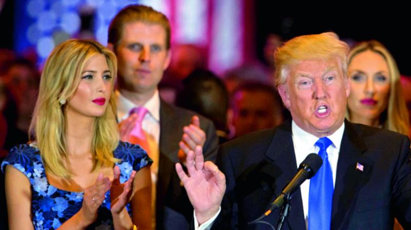 Republican presidential candidate Donald Trump is joined by his daughter Ivanka left and son Eric background left during a news conference