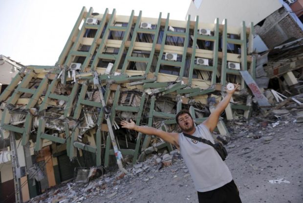 A resident gestures next to a collapsed building after an earthquake struck off the Pacific coast in Portoviejo Ecuador