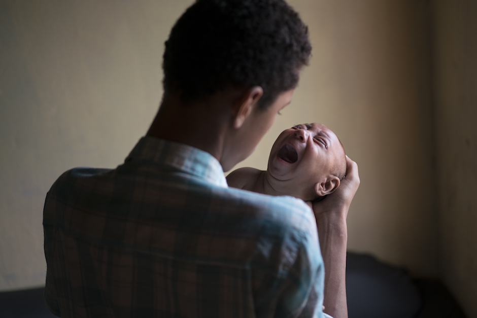 A baby affected by the Zika Virus in Bonito Pernambuco state Brazil is comforted by his elder brother