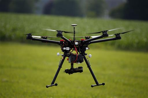 A hexacopter drone is flown during a drone demonstration at a farm and winery on potential use for board members of the National Corn Growers