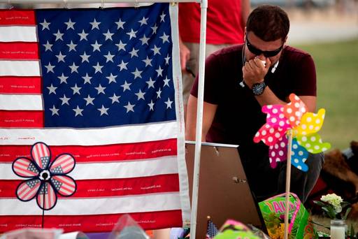 A man grieves at a memorial site for the victims of the Pulse nightclub shooting in Orlando Florida