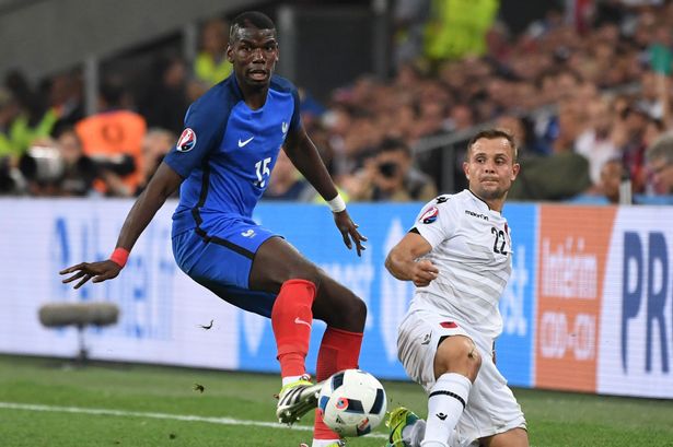 Paul Pogba and Amir Abrashi vie for the ball