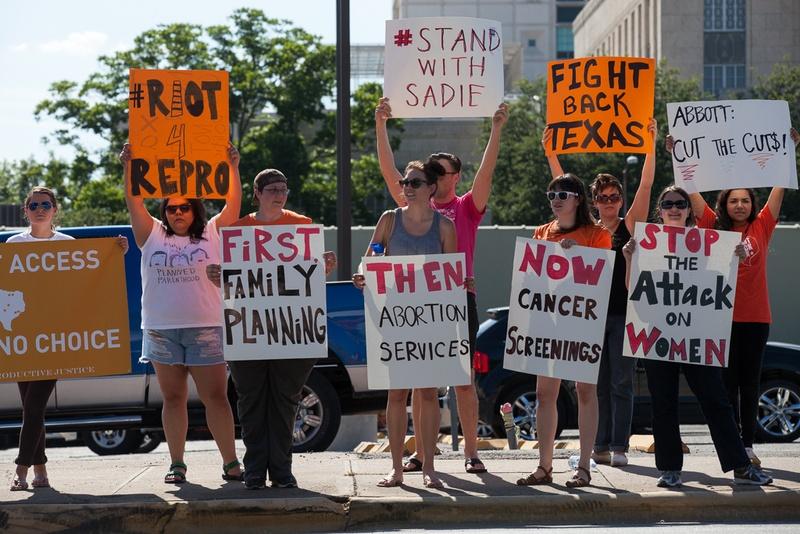 Abortion rights activists protest across from the governor's mansion in Austin