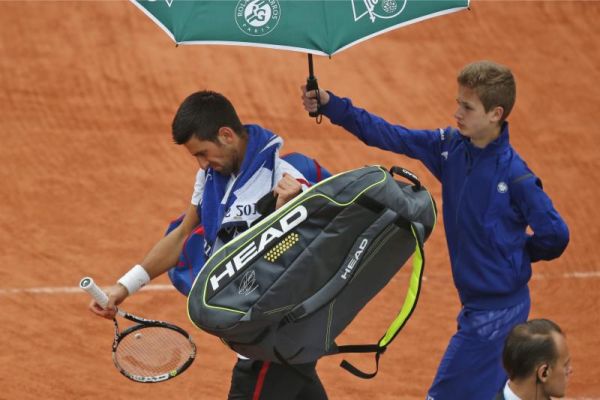 Serbia's Novak Djokovic leaves center court after rain