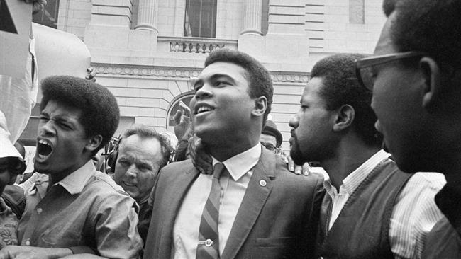 Muhammad Ali leaves the Armed Forces induction center with his entourage after refusing to be drafted into the Armed Forces in Houston Texas