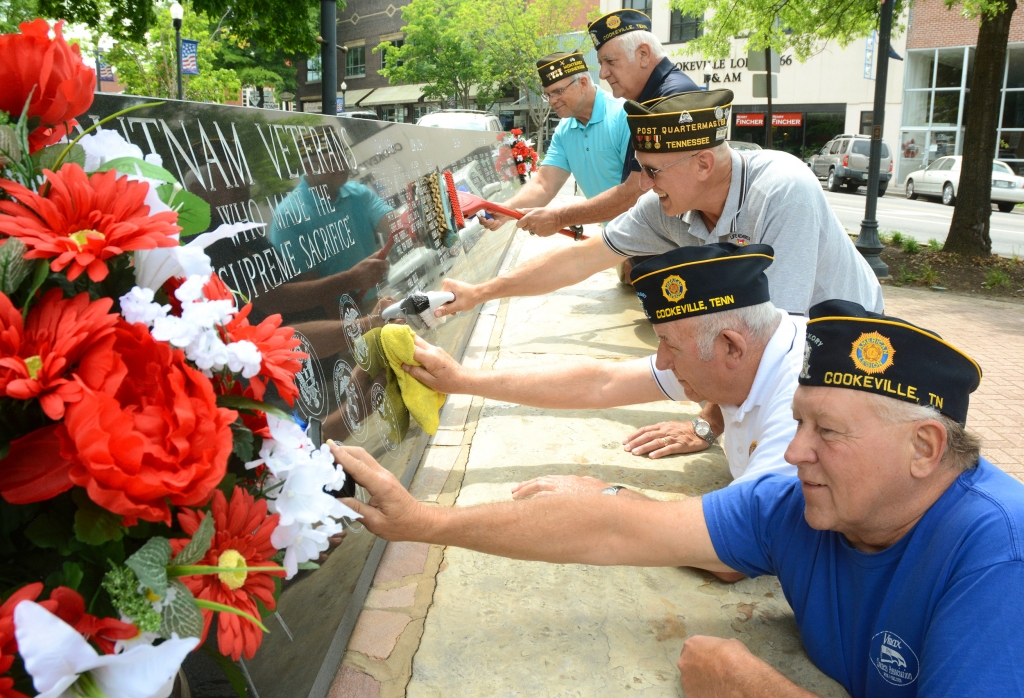 Putnam County veterans clean the memorial wall of Putnam veterans who were killed in wars and conflicts from World War I to Afghanistan and Iraq in preparation for a Memorial Day event Monday at the Putnam Courthouse at 11 a.m. In the foreground is Jim Ro