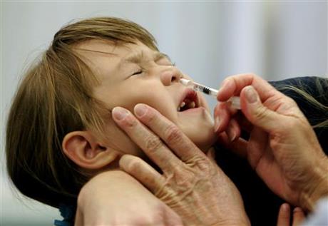 Danielle Holland reacts as she is given a Flu Mist influenza vaccination in St. Leonard Md. On Wednesday