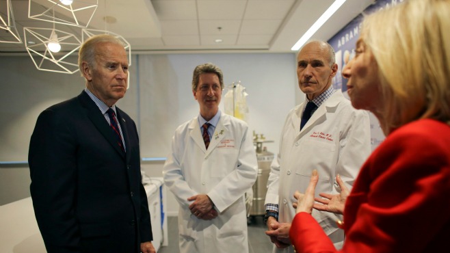 Vice President Joe Biden left listens to Dr. Amy Gutmann right speak as Dr. Bruce L. Livine PH.D. center and Dr. Carl H. June M.D. second from right Friday Jan. 14 2016 in the Abramson Cancer Center at the University of Pennsylvania in Philadelph