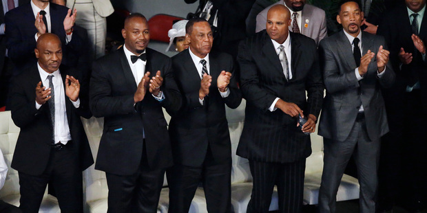 Pallbearers Mike Tyson left Lennox Lewis second from left Will Smith right and Mike Moorer second from right stand during Muhammad Ali's memorial service