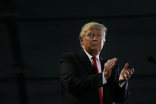 Republican presidential candidate Donald Trump applauds during a rally Thursday