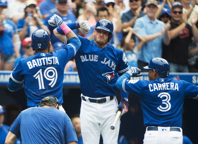 Toronto Blue Jays right fielder Jose Bautista celebrates with teammates Josh Donaldson and Ezequiel Carrera after hitting a two-run home run