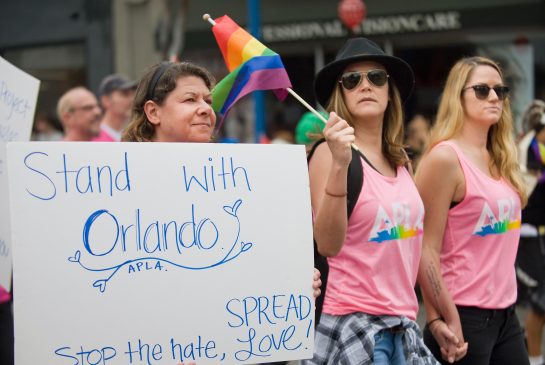 Pride Parade-goers remember the Orlando nightclub victims in Los Angeles Sunday. A gunman opened fire inside a crowded gay nightclub early Sunday before dying in a gunfight with SWAT officers police said